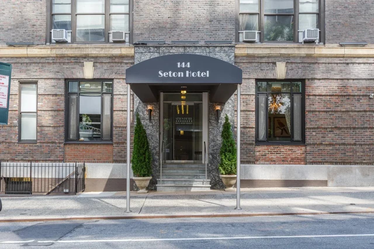 The entrance to 144 East 40th Street under its original Seton awning, seen from across the street in daylight