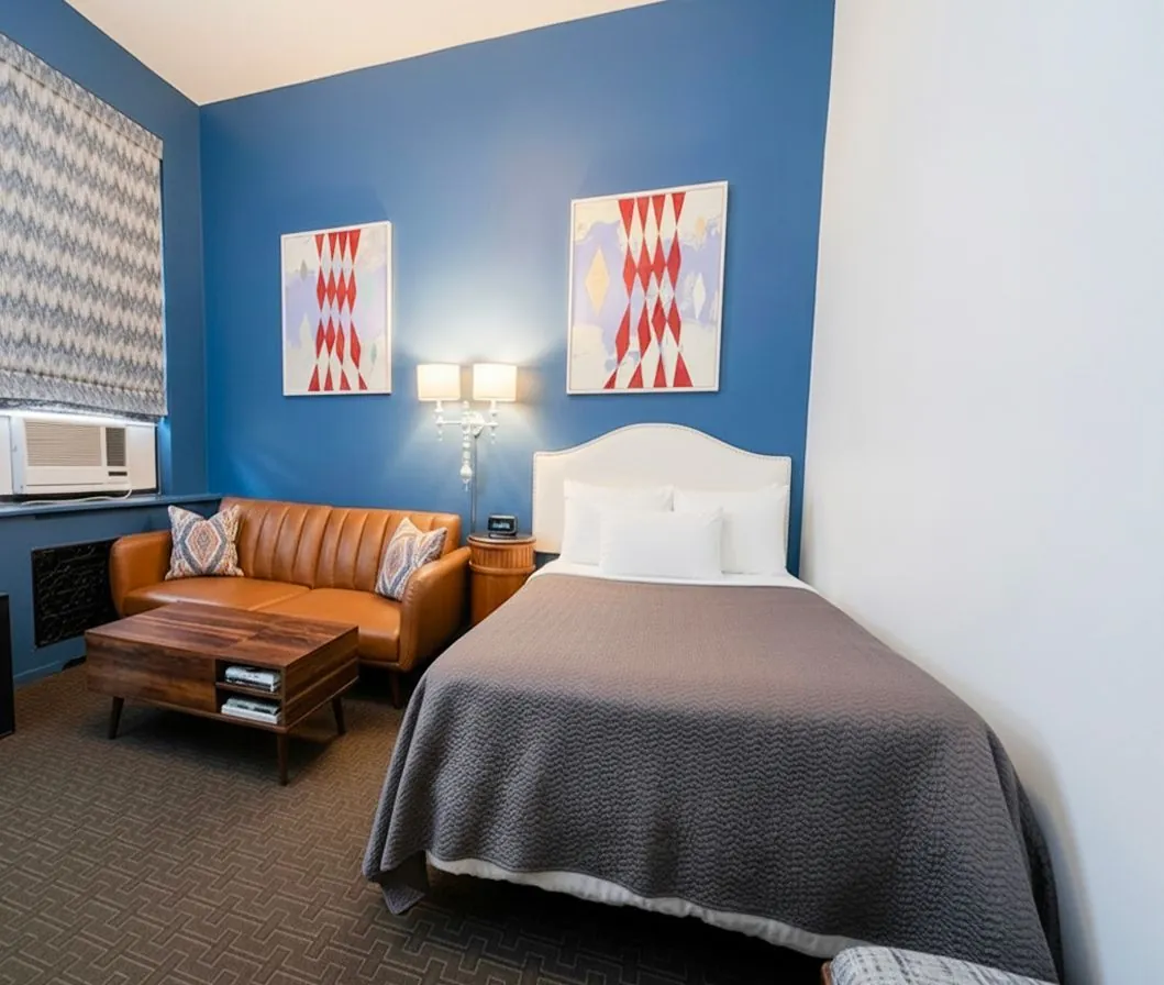 A King Studio with a leather sofa, pantry counter and queen bed